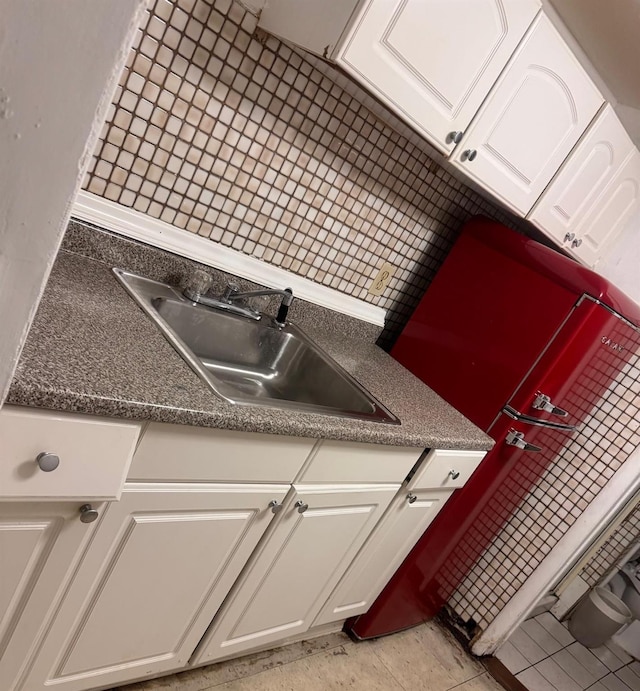 176 Floyd St, Brentwood, NY 11717 - kitchen featuring white cabinetry, tasteful backsplash, and dark countertops
