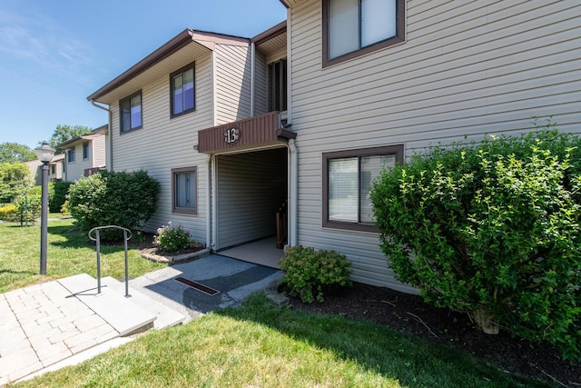 13 Knightsbridge Unit G, Poughkeepsie, NY 12603 - view of exterior entry featuring a lawn and a patio area