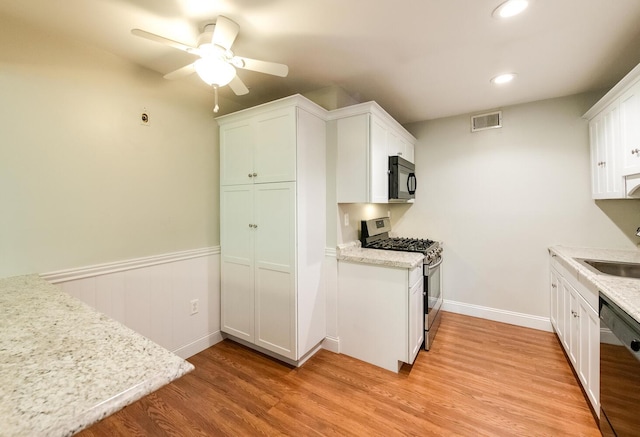 13 Knightsbridge Unit G, Poughkeepsie, NY 12603 - kitchen with stainless steel gas range, black microwave, dishwashing machine, light wood-style floors, and ceiling fan