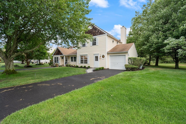 6 Doe Path, Coram, NY 11727 - traditional home featuring a garage, driveway, a chimney, and a front lawn