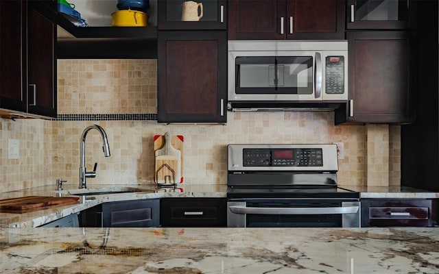 44 Hurlihe Unit 44, Poughkeepsie, NY 12601 - kitchen featuring stainless steel appliances, light stone counters, dark brown cabinets, and decorative backsplash
