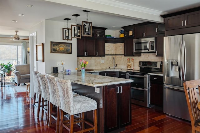 44 Hurlihe Unit 44, Poughkeepsie, NY 12601 - kitchen with stainless steel appliances, dark wood-type flooring, a peninsula, backsplash, and a kitchen breakfast bar