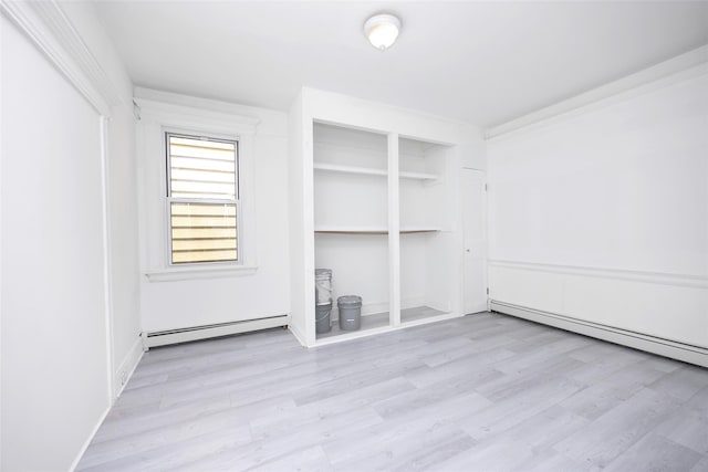 8808 88th St, Woodhaven, NY 11421 - spare room with baseboard heating and wood finished floors