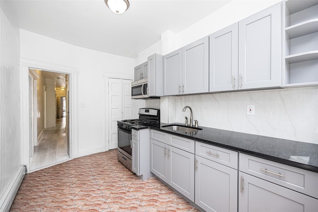 8808 88th St, Woodhaven, NY 11421 - kitchen featuring stainless steel appliances, a baseboard radiator, open shelves, decorative backsplash, and dark stone counters