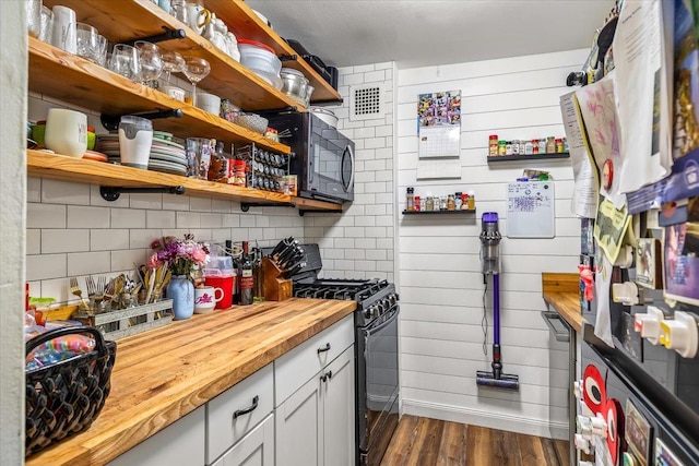 855 E Broadway Unit 4A, Long Beach, NY 11561 - kitchen featuring black appliances, butcher block countertops, dark wood-style floors, open shelves, and decorative backsplash