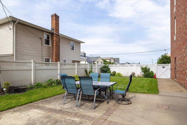 855 E Broadway Unit 4A, Long Beach, NY 11561 - fenced backyard featuring a patio area, a gate, and outdoor dining space