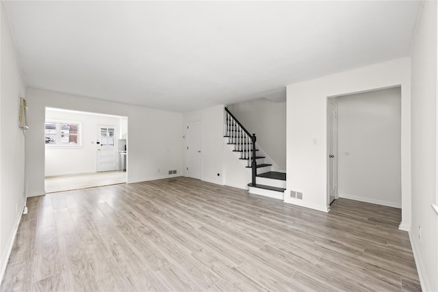 67-10 Bell Blvd, Bayside, NY 11364 - unfurnished living room featuring stairway and light wood finished floors
