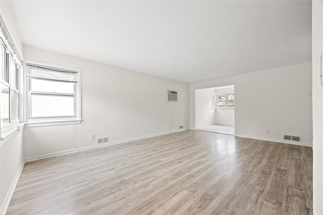 67-10 Bell Blvd, Bayside, NY 11364 - unfurnished room with light wood-style flooring and a wall mounted air conditioner