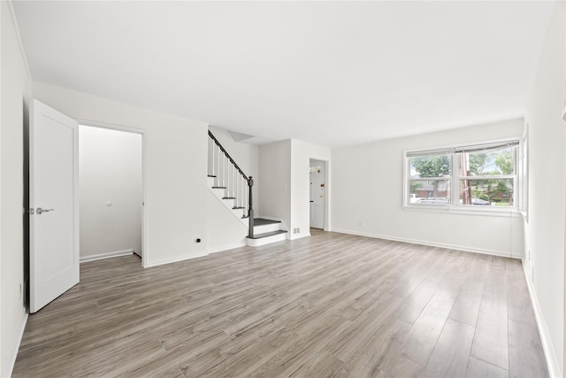 67-10 Bell Blvd, Bayside, NY 11364 - unfurnished living room with stairs and light wood finished floors