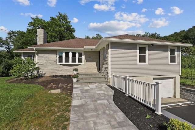 41 Forest Ave, Cortlandt Manor, NY 10567 - ranch-style house with a chimney, an attached garage, stone siding, and roof with shingles