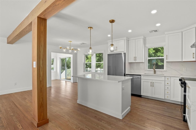 41 Forest Ave, Cortlandt Manor, NY 10567 - kitchen with appliances with stainless steel finishes, healthy amount of natural light, a kitchen island, tasteful backsplash, and recessed lighting