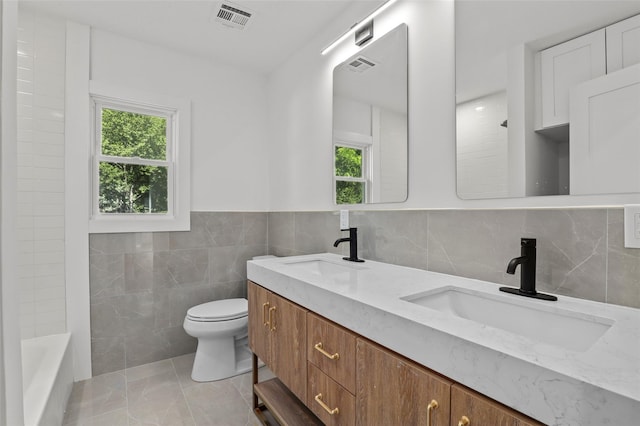 41 Forest Ave, Cortlandt Manor, NY 10567 - bathroom featuring tile walls, plenty of natural light, and double vanity