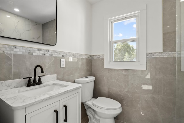 41 Forest Ave, Cortlandt Manor, NY 10567 - bathroom with tile walls, vanity, and a wainscoted wall