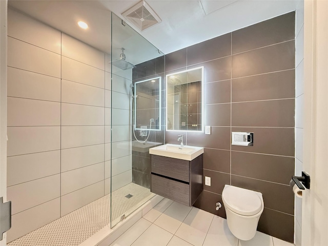 1238 63rd St Unit D306, Brooklyn, NY 11219 - bathroom with tile walls, tile patterned floors, a walk in shower, and vanity
