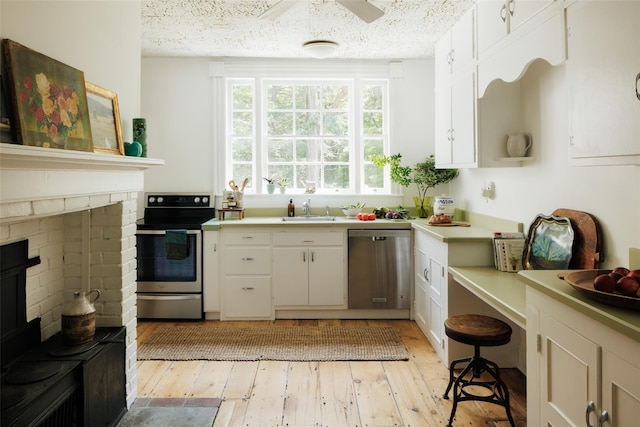 33 Scott Rd, Hudson, NY 12534 - kitchen featuring stainless steel appliances, light wood-type flooring, light countertops, and white cabinets