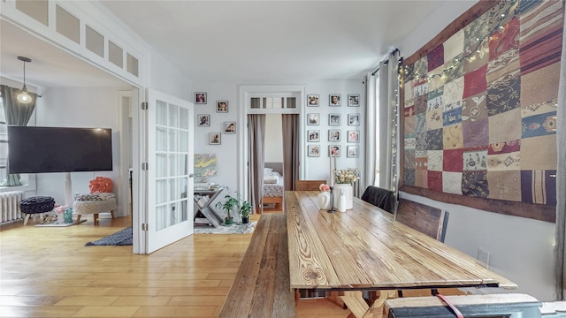 450 W 152nd St Unit 52, New York Manhattan, NY 10031 - dining area featuring wood-type flooring, french doors, and radiator