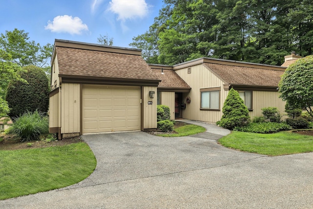 206 Heritage Unit A, Somers, NY 10589 - view of front facade with a shingled roof, driveway, a chimney, and an attached garage