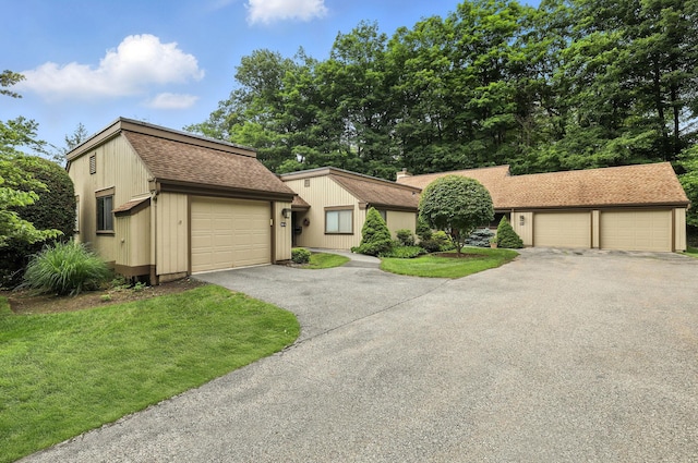 206 Heritage Unit A, Somers, NY 10589 - view of front of property with roof with shingles, a garage, a front yard, and driveway