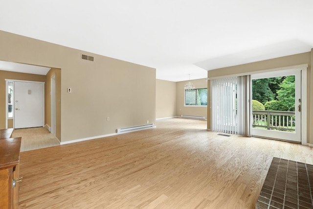 206 Heritage Unit A, Somers, NY 10589 - unfurnished room featuring a baseboard radiator, a chandelier, and light wood-style flooring