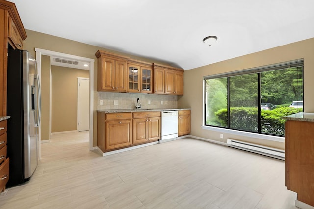 206 Heritage Unit A, Somers, NY 10589 - kitchen featuring stainless steel fridge, white dishwasher, a baseboard radiator, brown cabinetry, and backsplash