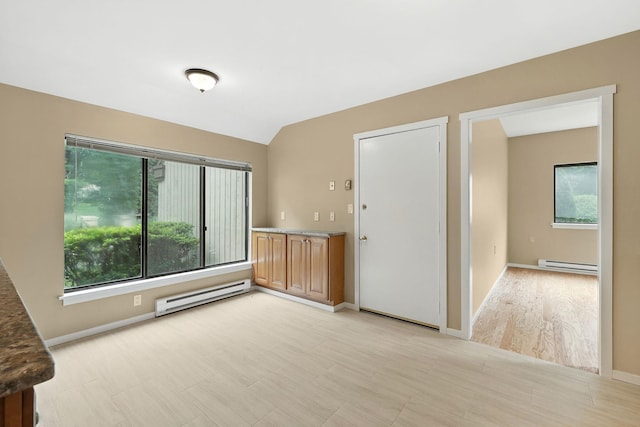 206 Heritage Unit A, Somers, NY 10589 - empty room featuring a baseboard heating unit, healthy amount of natural light, and lofted ceiling
