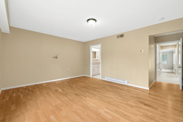 206 Heritage Unit A, Somers, NY 10589 - unfurnished room with baseboard heating, light wood finished floors, and a smoke detector