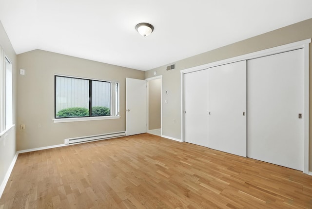 206 Heritage Unit A, Somers, NY 10589 - unfurnished bedroom with a baseboard radiator, light wood-style floors, and a closet