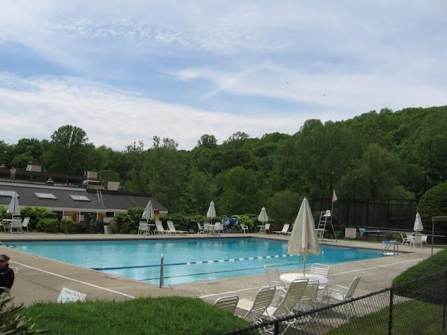 206 Heritage Unit A, Somers, NY 10589 - community pool featuring a patio and a wooded view