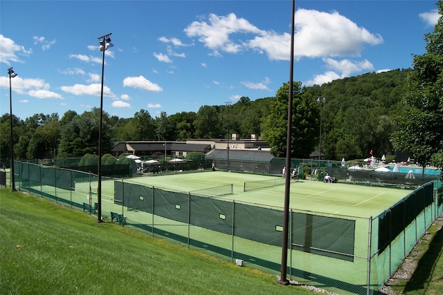 206 Heritage Unit A, Somers, NY 10589 - view of tennis court with a forest view