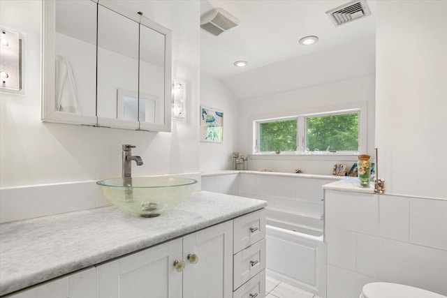 82 Wood Hollow Ln, New Rochelle, NY 10804 - bathroom with a bath, vanity, and vaulted ceiling
