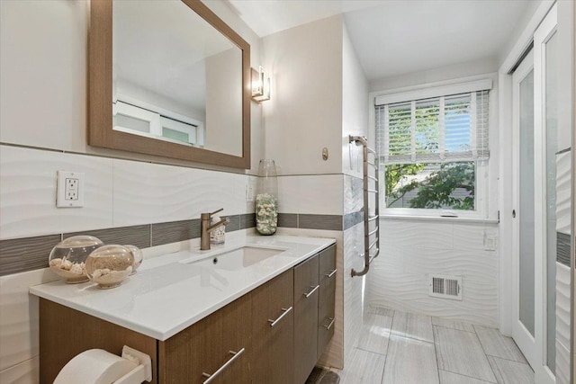 82 Wood Hollow Ln, New Rochelle, NY 10804 - bathroom featuring vanity, tile walls, and tile patterned floors