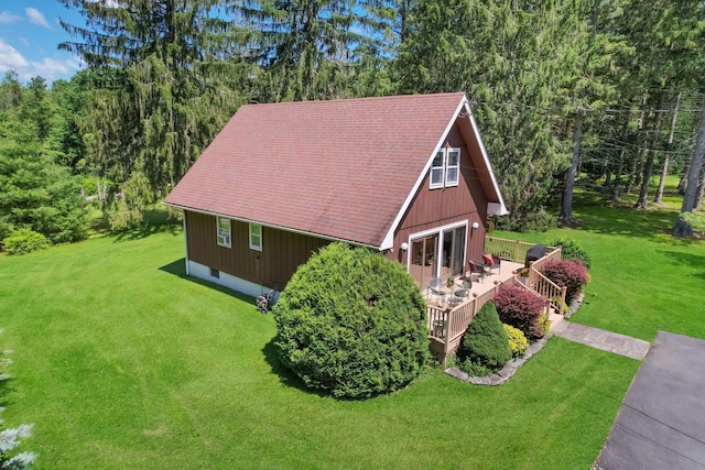 75 Hartung Rd, Eldred, NY 12743 - view of home's exterior featuring a lawn, a wooden deck, a wooded view, and roof with shingles