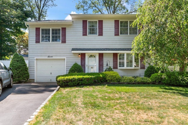 7 Mildred Ct, Nesconset, NY 11767 - view of front facade with asphalt driveway, an attached garage, and a front lawn