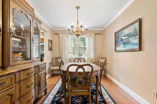 7 Mildred Ct, Nesconset, NY 11767 - dining space featuring a chandelier, light wood-style flooring, and ornamental molding
