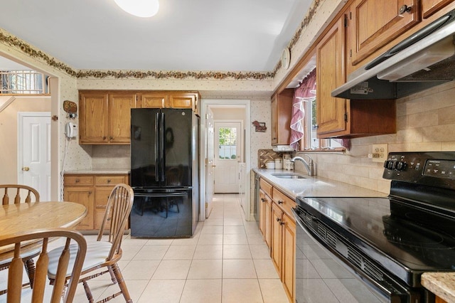 7 Mildred Ct, Nesconset, NY 11767 - kitchen featuring black appliances, under cabinet range hood, light countertops, light tile patterned floors, and tasteful backsplash