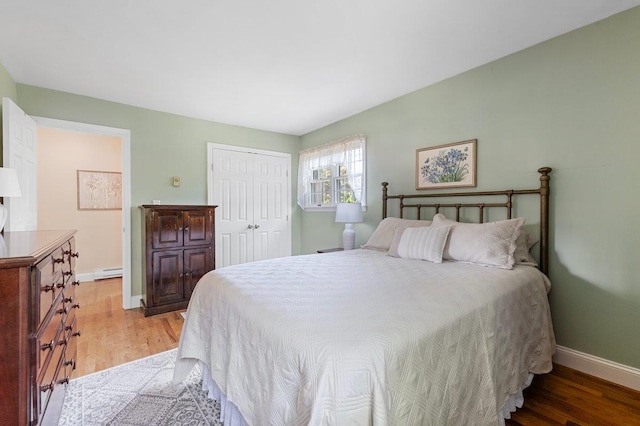 7 Mildred Ct, Nesconset, NY 11767 - bedroom featuring light wood-style floors, baseboard heating, and a closet