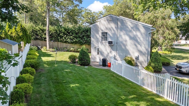 7 Mildred Ct, Nesconset, NY 11767 - view of property exterior featuring a fenced backyard and a storage unit