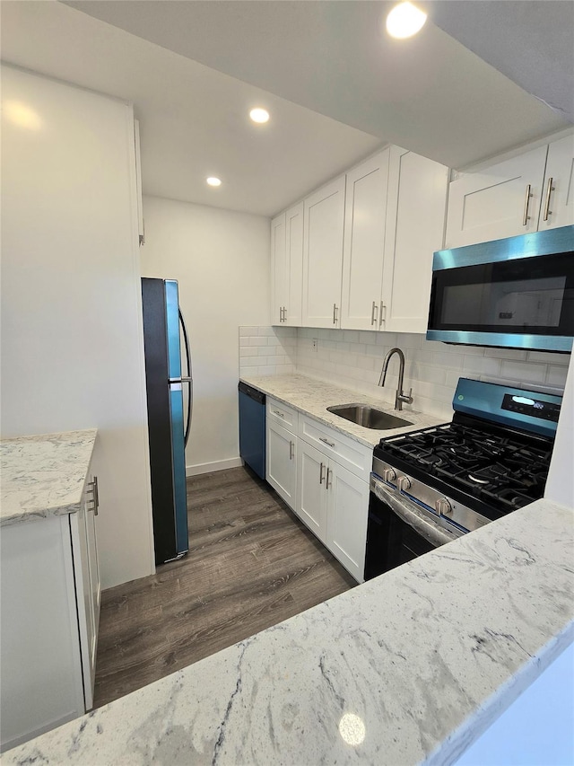 89-40 151st Ave Unit 5F, Howard Beach, NY 11414 - kitchen featuring stainless steel appliances, white cabinets, decorative backsplash, dark wood finished floors, and light stone counters