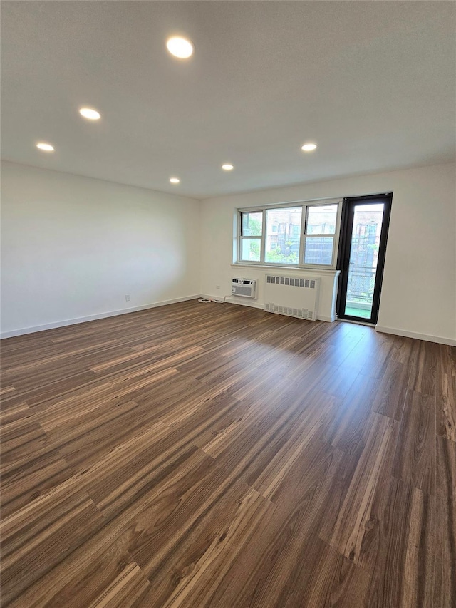 89-40 151st Ave Unit 5F, Howard Beach, NY 11414 - unfurnished room with radiator, dark wood-type flooring, a wall unit AC, and recessed lighting