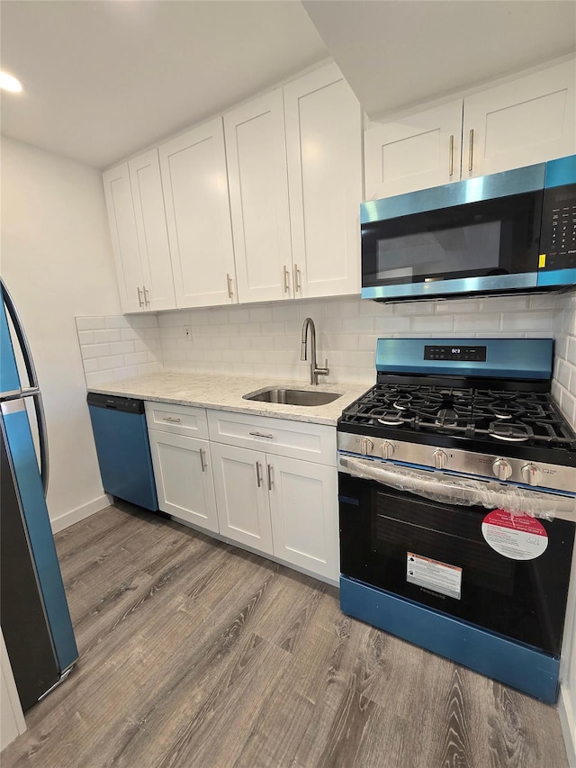 89-40 151st Ave Unit 5F, Howard Beach, NY 11414 - kitchen featuring stainless steel appliances, light wood-style flooring, and white cabinetry