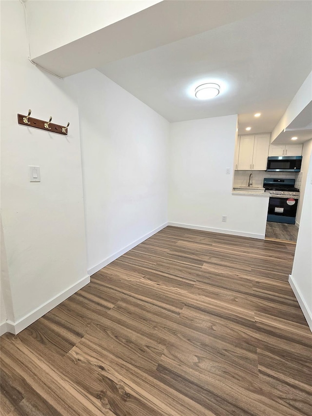 89-40 151st Ave Unit 5F, Howard Beach, NY 11414 - unfurnished dining area featuring dark wood-type flooring and recessed lighting