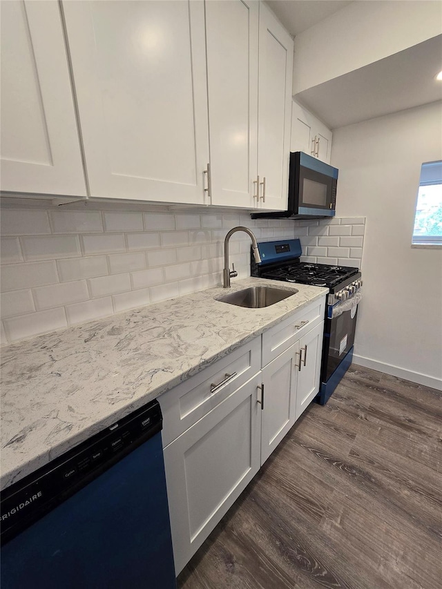 89-40 151st Ave Unit 5F, Howard Beach, NY 11414 - kitchen with stainless steel gas range oven, dishwasher, black microwave, dark wood-type flooring, and white cabinets