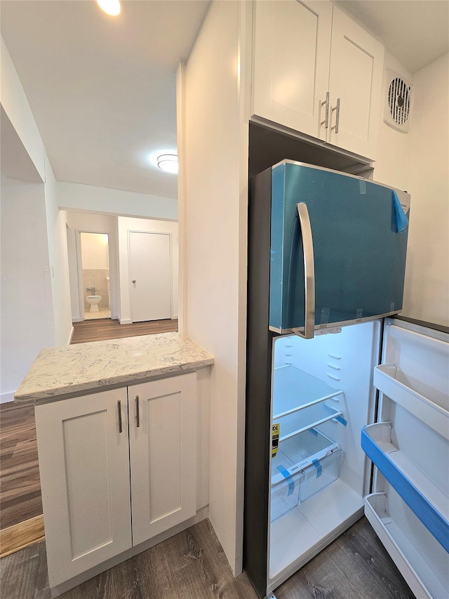 89-40 151st Ave Unit 5F, Howard Beach, NY 11414 - kitchen with freestanding refrigerator, dark wood finished floors, light stone countertops, and white cabinetry
