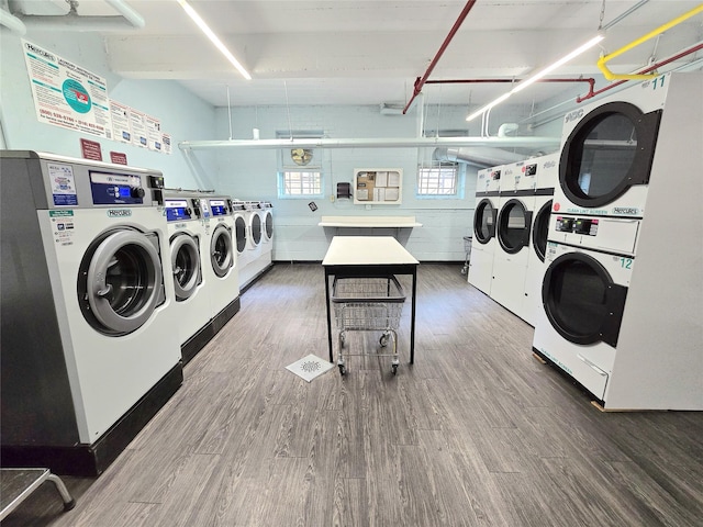 89-40 151st Ave Unit 5F, Howard Beach, NY 11414 - communal laundry room with wood finished floors, washing machine and clothes dryer, and stacked washer and clothes dryer