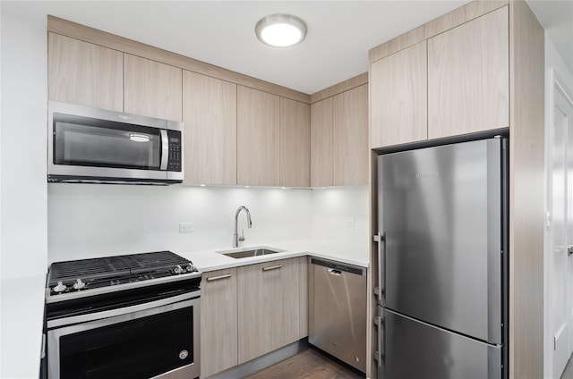 5700 Arlington Ave Unit 12T, Bronx, NY 10471 - kitchen featuring appliances with stainless steel finishes, light brown cabinetry, and modern cabinets