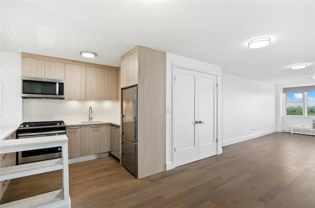 5700 Arlington Ave Unit 12T, Bronx, NY 10471 - kitchen featuring stainless steel appliances, light brown cabinetry, light countertops, and dark wood-style flooring