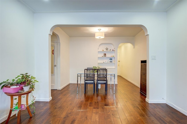 111-39 76th Rd Unit E2, Forest Hills, NY 11375 - dining room featuring arched walkways, dark wood-style floors, and built in features
