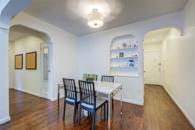 111-39 76th Rd Unit E2, Forest Hills, NY 11375 - dining room featuring arched walkways, dark wood-style flooring, and built in features