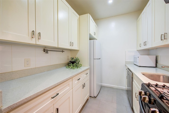 111-39 76th Rd Unit E2, Forest Hills, NY 11375 - kitchen featuring white appliances, light tile patterned flooring, white cabinetry, recessed lighting, and light stone counters