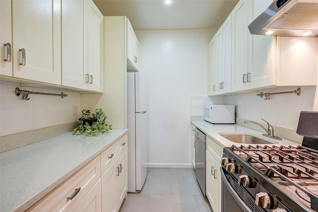 111-39 76th Rd Unit E2, Forest Hills, NY 11375 - kitchen featuring appliances with stainless steel finishes, range hood, white cabinets, and light tile patterned floors
